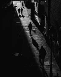 People walking on footpath in city