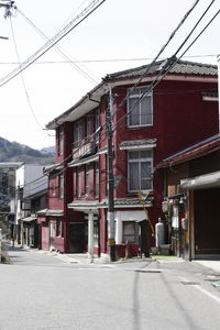 Street by buildings against sky in city