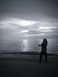 Woman on the beach early in the morning searching for relaxation.