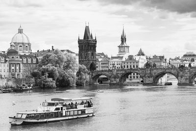 Bridge over river against buildings in city