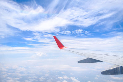 Airplane wing against sky