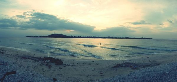 Scenic view of beach at sunset