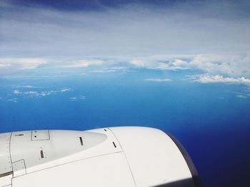 Cropped image of airplane flying over landscape