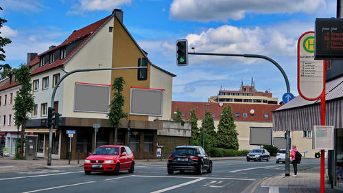 Cars on road against buildings in city