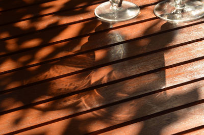 Shadow of glasses on wooden table