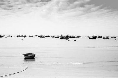 Boats moored on sea against sky