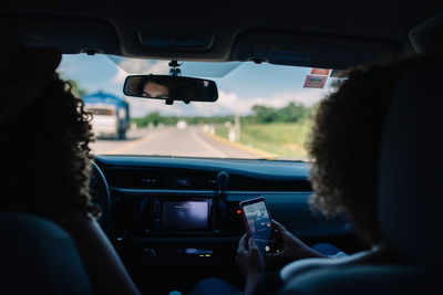 Side view of woman sitting in car