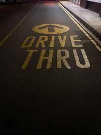 High angle view of arrow sign on road in city