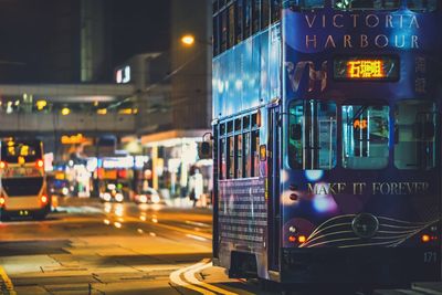 Close-up of illuminated cars in city at night