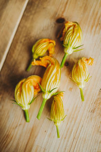 High angle view of yellow flowers on table