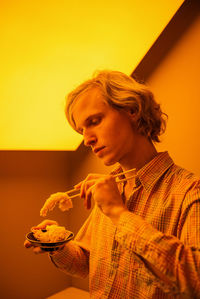 Portrait of young man smoking cigarette