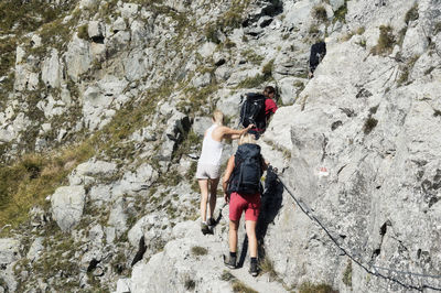 Rear view of people on rock