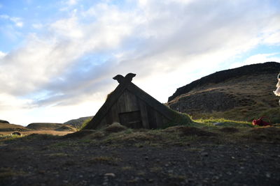 Built structure on field against sky