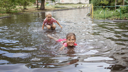 Portrait of smiling girl swimming in lake