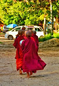 Rear view of couple walking on road