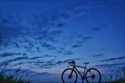 Bicycle against sky during sunset