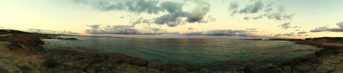 Scenic view of sea against cloudy sky