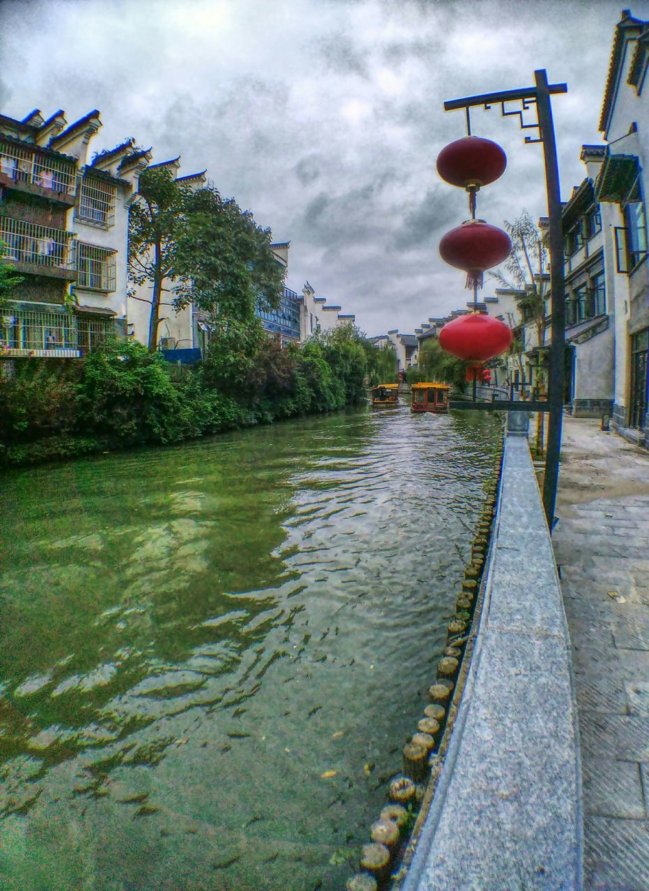 architecture, built structure, building exterior, water, sky, cloud - sky, cloudy, river, cloud, reflection, day, city, canal, street light, tree, outdoors, house, waterfront, no people, overcast