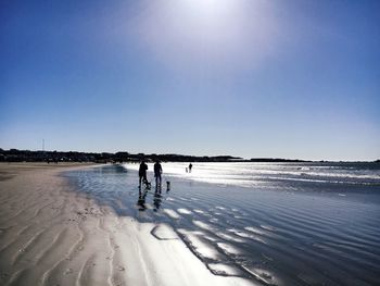 Scenic view of beach against clear blue sky