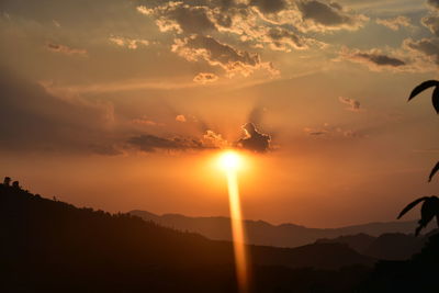 Scenic view of silhouette mountains against sky during sunset