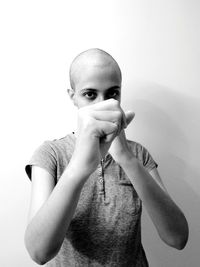 Portrait of teenage girl standing against white background