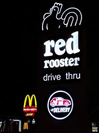 Low angle view of information sign against black background