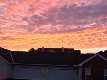 Low angle view of silhouette building against sky during sunset