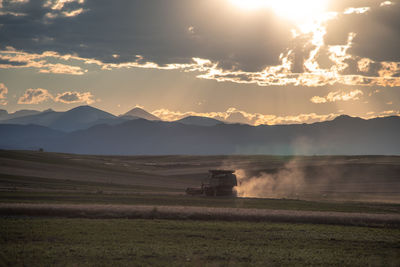 Scenic view of field against sky during sunset