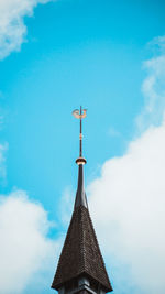 Low angle view of weather vane against sky