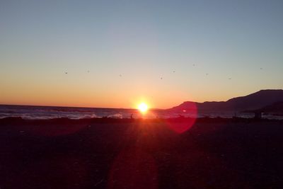Scenic view of sea against clear sky during sunset