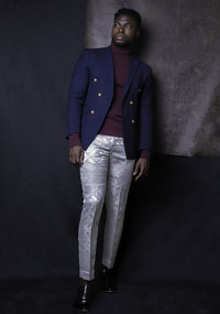 Portrait of woman standing against wall