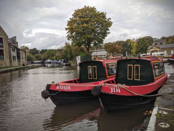 Boat moored on river against sky