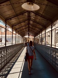 Rear view of woman walking in train