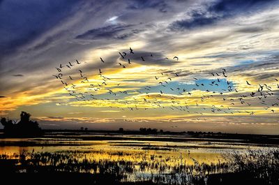 Scenic view of lake against sky during sunset