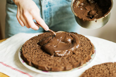 Midsection of man preparing cake