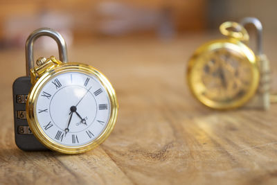 Close-up of pocket watch on wooden table