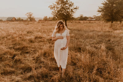 Young woman standing on grassy field