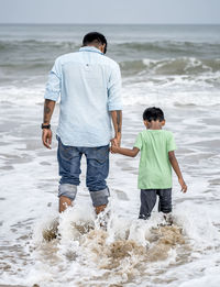 Father and son enjoying in the beach.