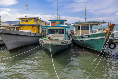 Boats moored in sea against sky