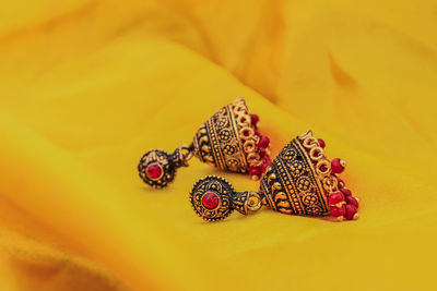 Close-up of earrings on fabric