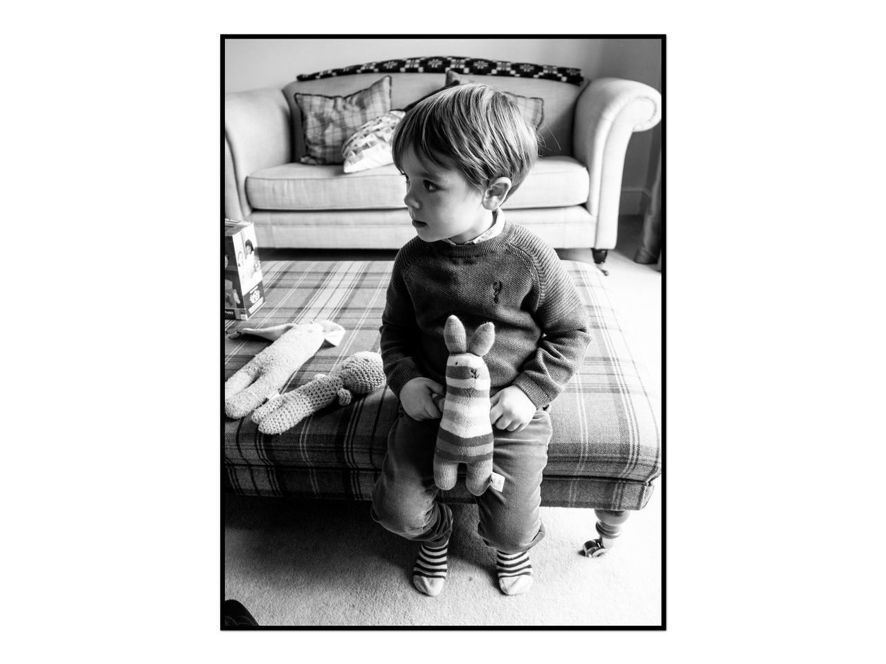 BOY SITTING ON TOY AT HOME