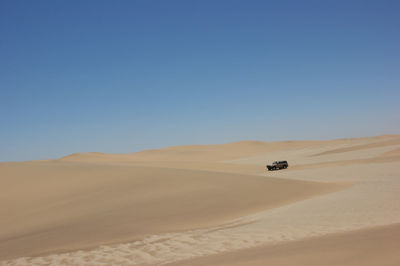 Scenic view of desert against clear sky