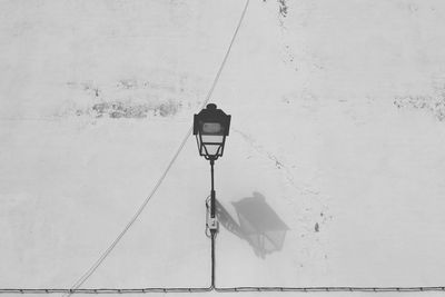 Street light hanging on snow covered wall