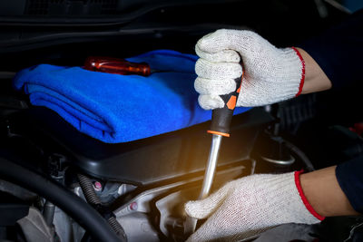 Close-up of man working in car