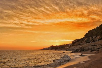 Scenic view of beach against sky during sunset