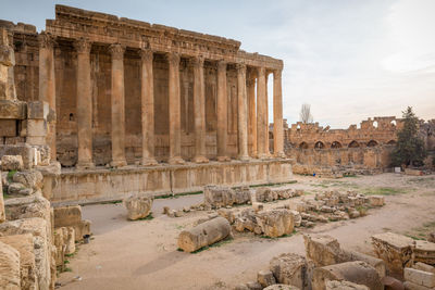 Old ruins of temple against sky in city