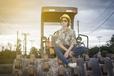 Female architect sitting on bulldozer