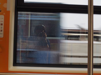 Woman photographing through train window