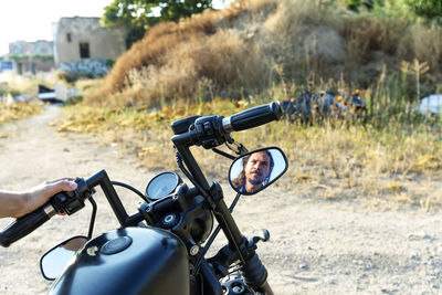 Reflection of man in side view mirror