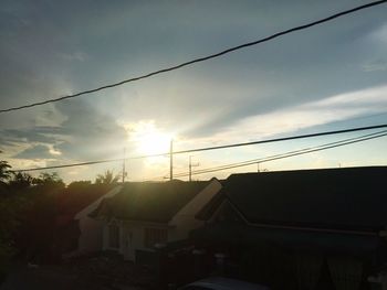 Low angle view of built structures against sky at sunset